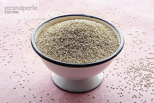 Quinoa in a bowl  healthy organic wood  uncooked  in a white bowl on a pink background  Food photography  Food photography