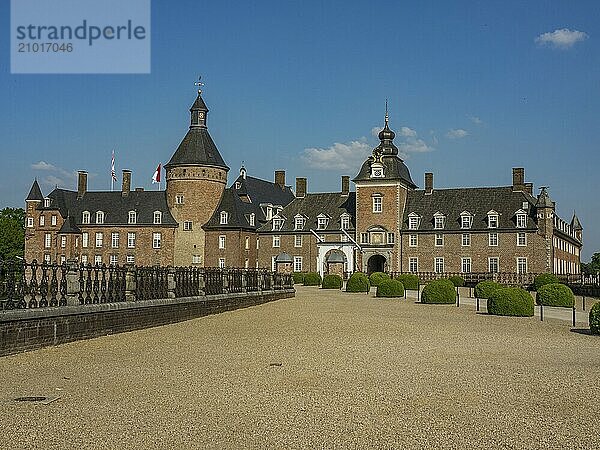 Wide view of a historic brick castle with a large courtyard and garden  Anholt  North Rhine-Westphalia  Germany  Europe