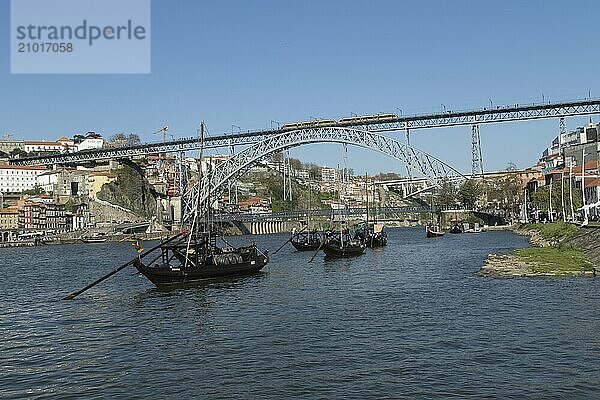 Place of interest  architecture  view from Vila Nova de Gaia to Rabelos  boats on the river Douro and the bridge Ponte Dom Luis I with light railway of the Metro do Porto  Porto  Portugal  Europe