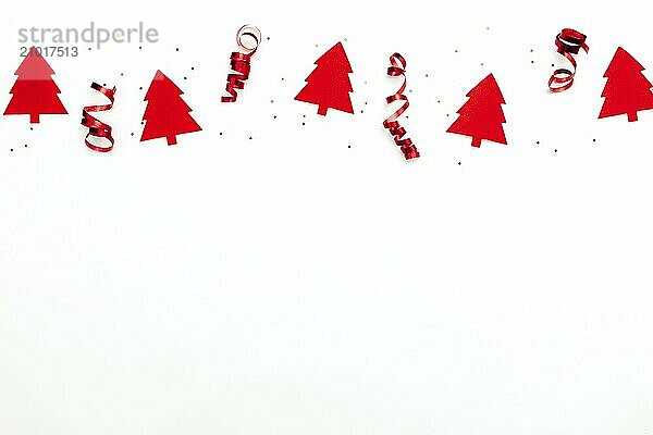 Christmas trees with red ribbons and glitter stars on white background.