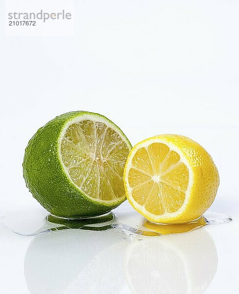 A close up of a lemon and lime sliced open on a white background