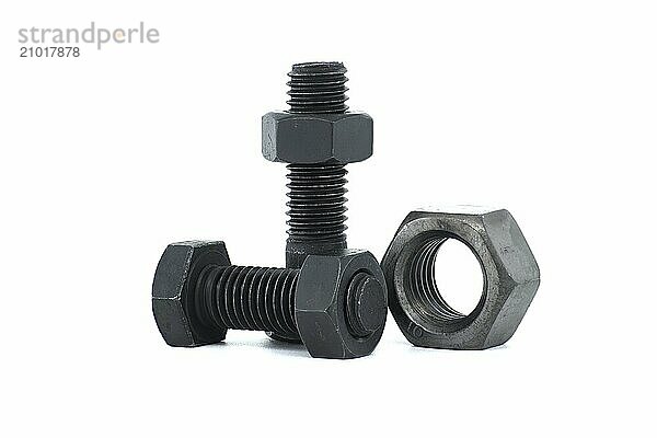 Black metal hexagonal bolts and nuts shown in close-up isolated on white background