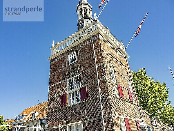 Old tower with flags and historical architecture on a sunny day  alkmaar  the netherlands