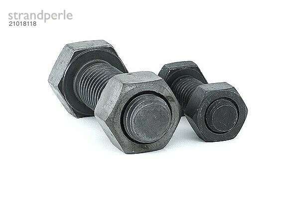 Black metal hexagonal bolts and nuts shown in close-up isolated on white background