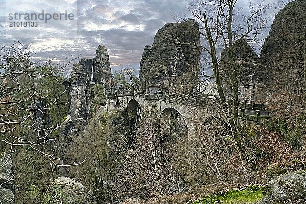 The Bastei Bridge in Saxon Switzerland. jagged rocks  viewing platform overlooking the Elbe. Tourist attraction. Dramatic sky. National park in Germany