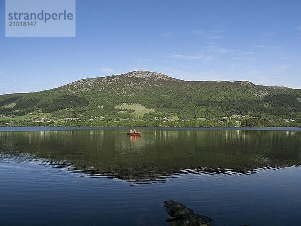 Two anglers in a boat on the Hjørungdalsvatnet in Norway