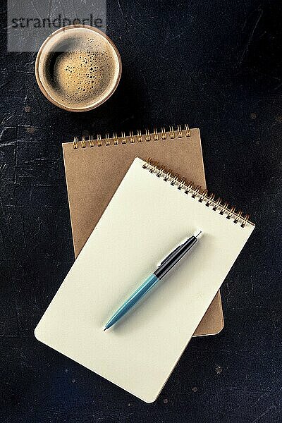 Notebook mockup with a pen and a cup of coffee  top shot on a black background  Food photography  Food photography