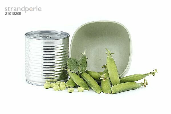 Steel can near fresh garden peas pods with green leaves isolated on a white background  sweet peas or English peas