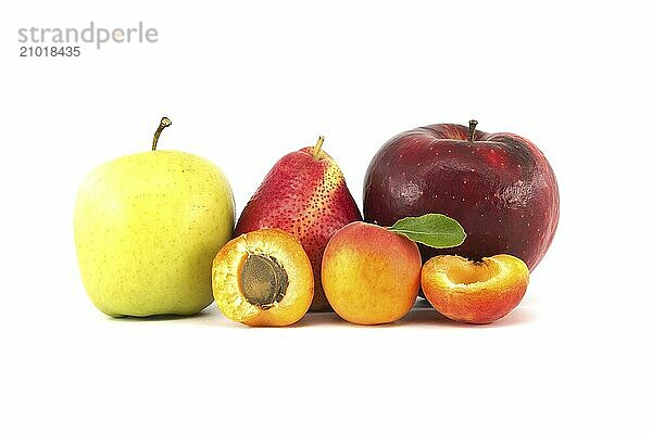 Whole and halved ripe apricots  multicolored pear  red and green apples isolated on a white background. Multivitamin and juicy rich fruit