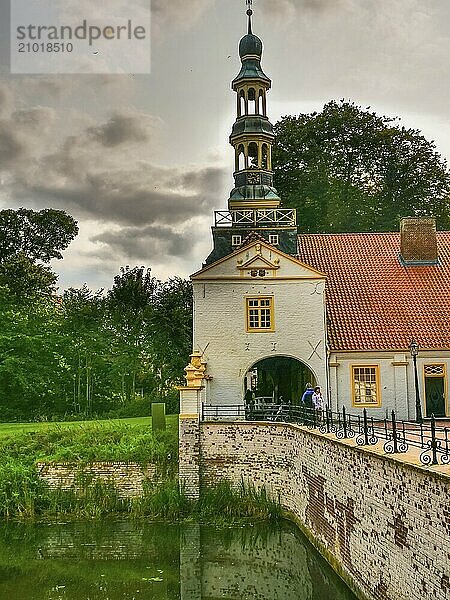 Castle with tower  moat and bridge  cloudy sky  dornum  east frisia  germany