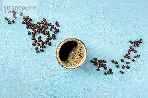 Coffee cup and coffee beans  top shot on a blue background with copy space  menu banner design  a flat lay composition  Food photography