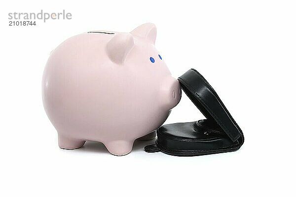 Pink piggy bank alongside a black wallet which is open showing some bills  isolated on a white background