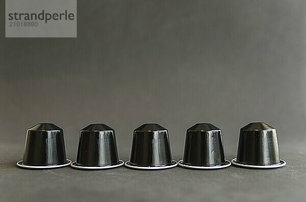 Beautiful colored coffee capsules on black background