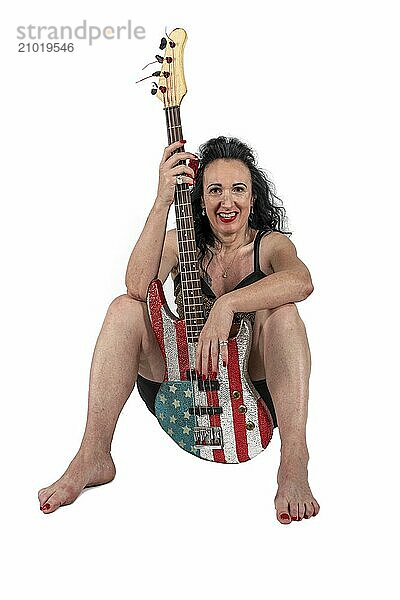 Woman with an electric guitar on a white background. Studio recording