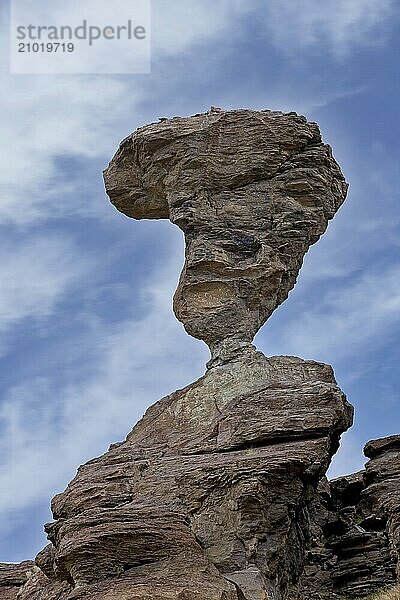 A clear photo of the famous balanced rock set against a partly cloudy sky near Buhl  Idaho