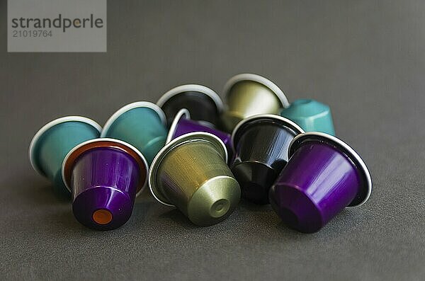 Beautiful colored coffee capsules on black background