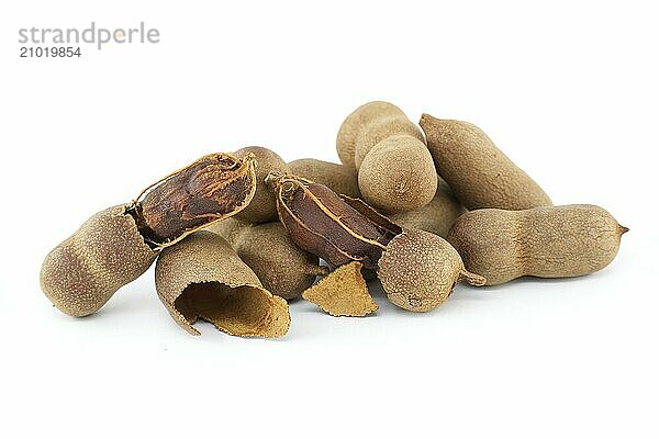 Pile of fresh whole tamarinds fruits isolated on white background