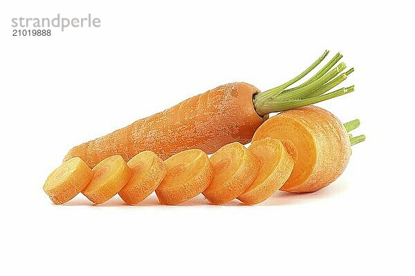 Whole carrot alongside its sliced pieces  each exhibiting a vibrant orange hue  set against a white background