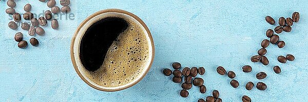 Coffee cup and beans panorama  top flat lay shot on a blue background  a panoramic banner for a menu  Food photography