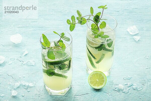 Mojito cocktail. Summer cold drink with lime  fresh mint  and ice. Cool beverage  side view on a blue background  Food photography  Food photography