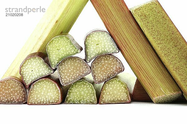 Variety of rhubarb stalks of varying colors from pale green to deep red isolated on white background  health benefits of eating rhubarb