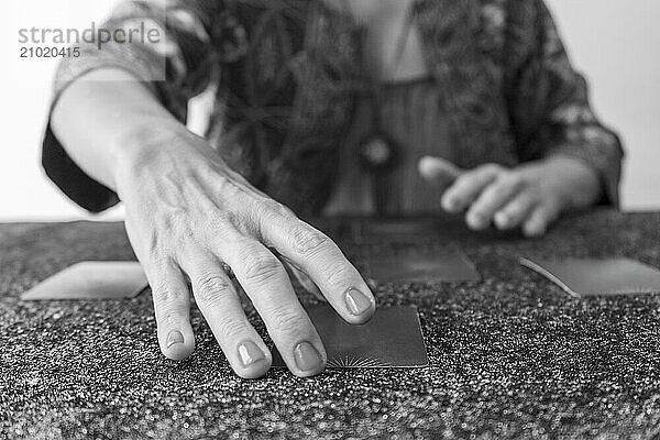 Tarot reader presenting the cards  poised to uncover the secrets they hold