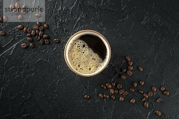 Coffee cup and beans  top shot on a dark background with copy space  menu banner design  a flat lay