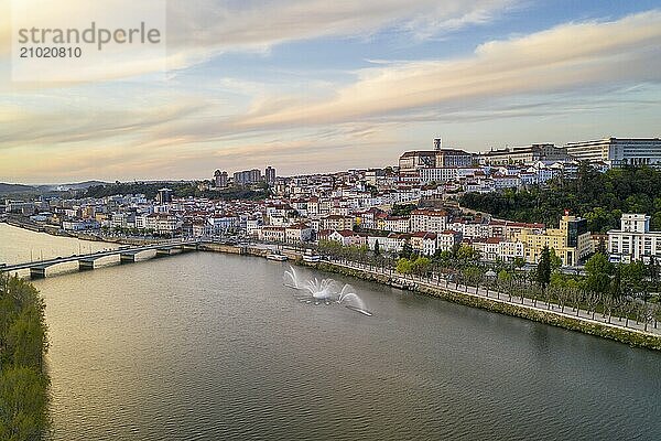 Coimbra drone aerial city view at sunset with Mondego river and beautiful historic buildings  in Portugal