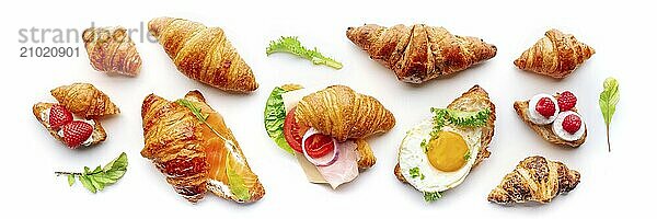 Croissant sandwich variety panorama. Different stuffed croissants  overhead flat lay shot on a white background. Rolls filled with ham  salmon  egg  etc  Food photography  Food photography