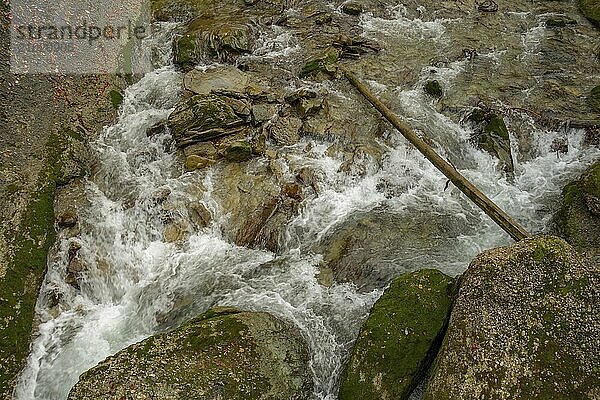 A flowing stream in a rocky  autumnal setting  oberstaufen  allgäu  bavaria  germany