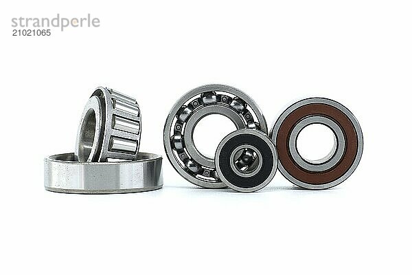 Ball bearings and tapered roller bearing isolated on white background. Car bearings  auto parts  automobile components for the engine and chassis suspension