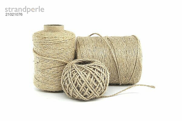 Three spools of jute twine isolated on white background  each varying in size  made from natural jute materials