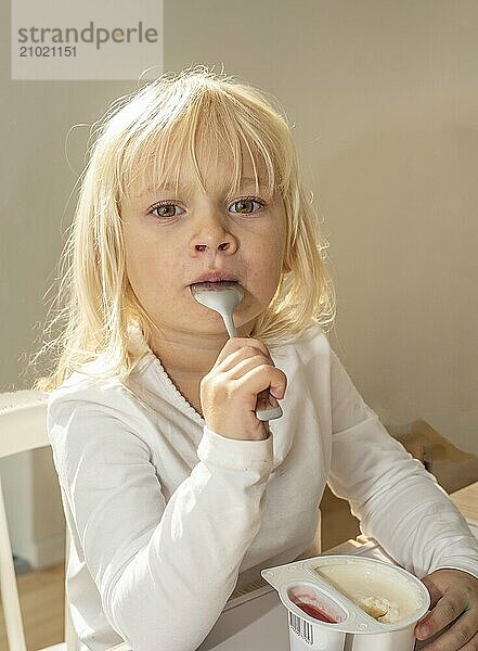 Portrait of blonde girl  3 years old  having lunch in Ystad  Skåne County  Sweden  Scandinavia  Europe