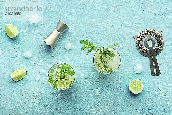 Mojito cocktail. Summer cold drink with lime  fresh mint  and ice. Cool beverage on a blue background  overhead flat lay shot  Food photography  Food photography