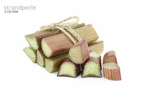 Close up of rhubarb stalks tied together with a string isolated on white background  health benefits of eating rhubarb