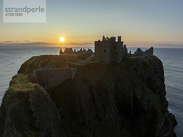 Dunnottar Castle  castle ruins at sunrise on the cliffs  drone shot  Stonehaven  Aberdeenshire  Scotland  Great Britain