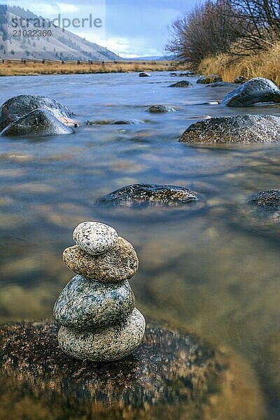 A rock cairn is on a wet rock in the Salmon River near Stanley  Idaho