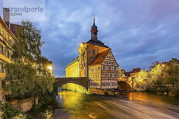 Old Town Hall on an artificial island in the River Regnitz. The landmark can be reached via two arched bridges. Night shot. City view of Bamberg  Upper Franconia  Bavaria  Germany  Europe