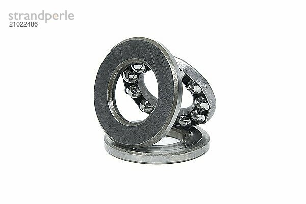 Thrust ball bearing isolated on white background  bearing are stacked upon each other  showcasing the inner structure