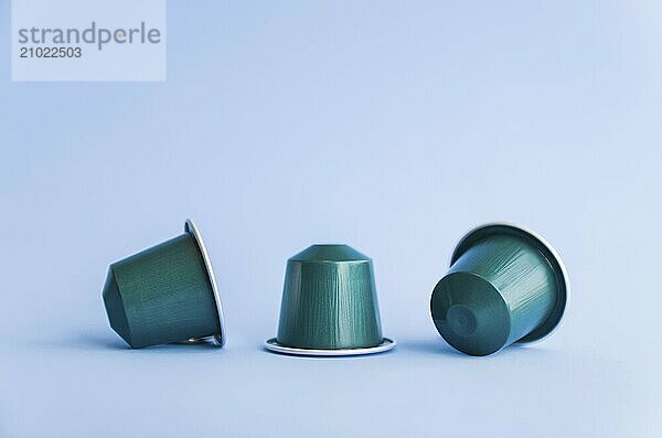 Beautiful colored coffee capsules on light blue background