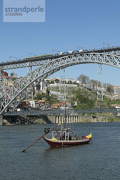 Place of interest  architecture  view from Vila Nova de Gaia to a Rabelo  boat on the river Douro and the bridge Ponte Dom Luis I with light railway of the Metro do Porto  Porto  Portugal  Europe