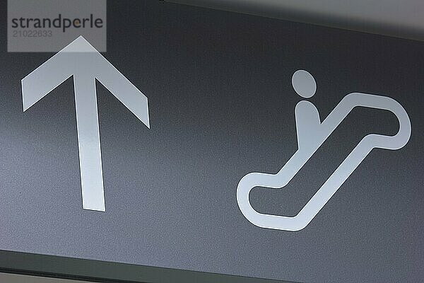 Symbolic image of an escalator and a directional arrow on a grey background  Toronto Airport  Ontario  Canada  North America