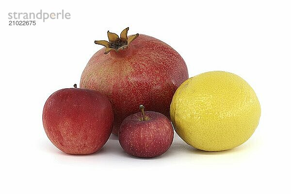 Fresh ripe pomegranate  red apples and whole yellow lemon isolated on white background