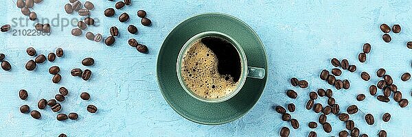 Coffee cup and coffee beans panorama  overhead flat lay shot on a blue background  panoramic menu banner design  Food photography  Food photography