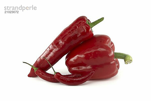 A stack of fresh chili peppers and red bell peppers isolated on white background