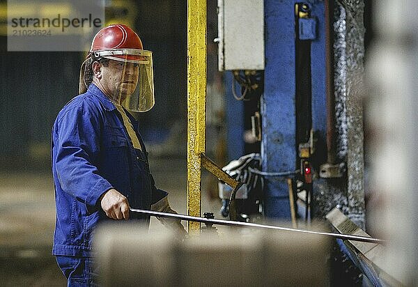 A worker stands at a boiler during a galvanising process. Taken during a press event at The Coatinc Company in Siegen  22/08/2024