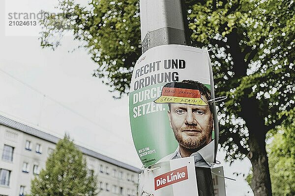 A defaced poster of Michael Kretschmer  Prime Minister of Saxony  hangs on a lamppost  taken in Dresden  31 August 2024. A new state parliament will be elected in Saxony on 1 September