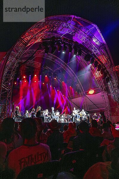 Large concert on an illuminated stage with orchestra  surrounded by an impressed audience  Klostersommer  Calw Hirsau  Black Forest  Germany  Europe