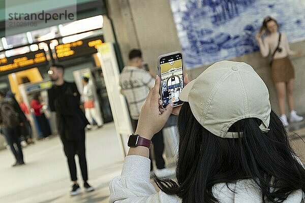 Sightseeing Porto-Campanhã railway station  a tourist takes a photo with her smartphone  Porto  Portugal  Europe