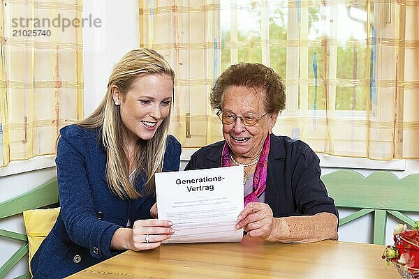 A grandson visits his grandmother and reads a generational contract  Vienna  Austria  Europe